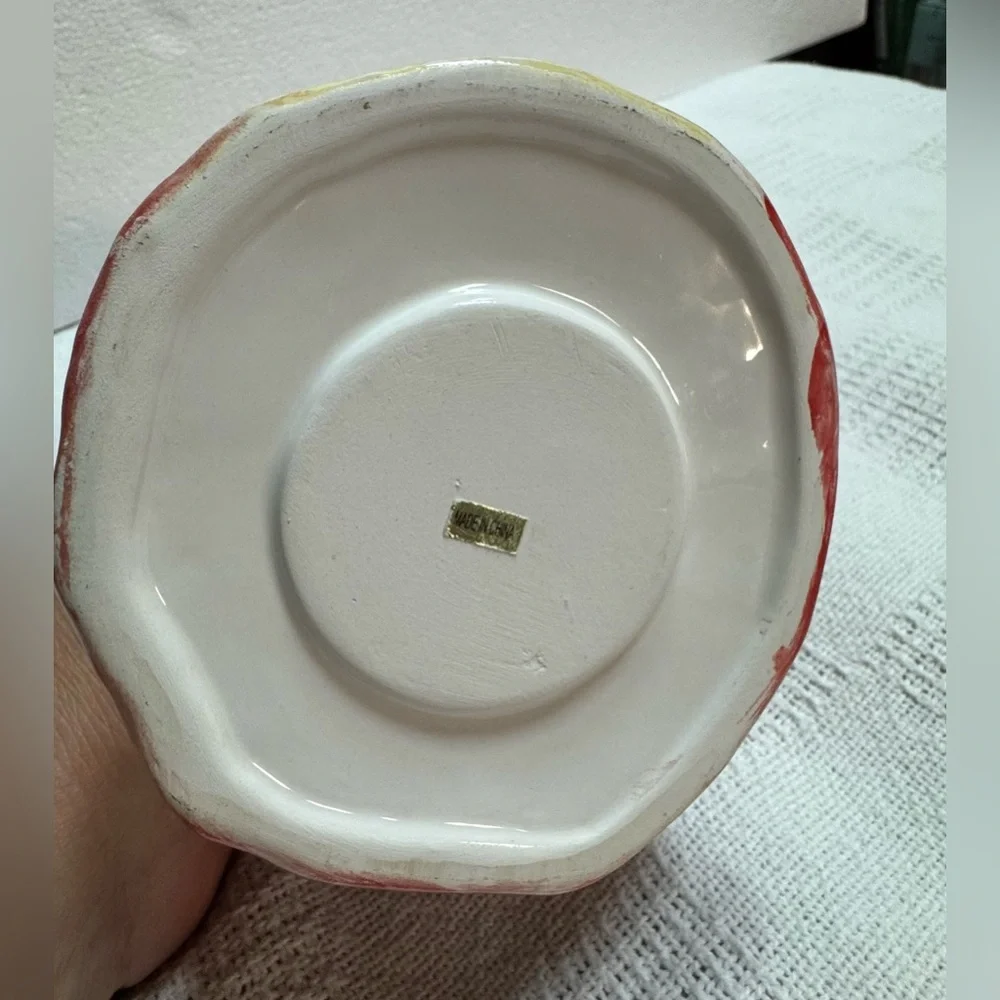 This is a vintage ceramic strawberry candle or tealight holder,